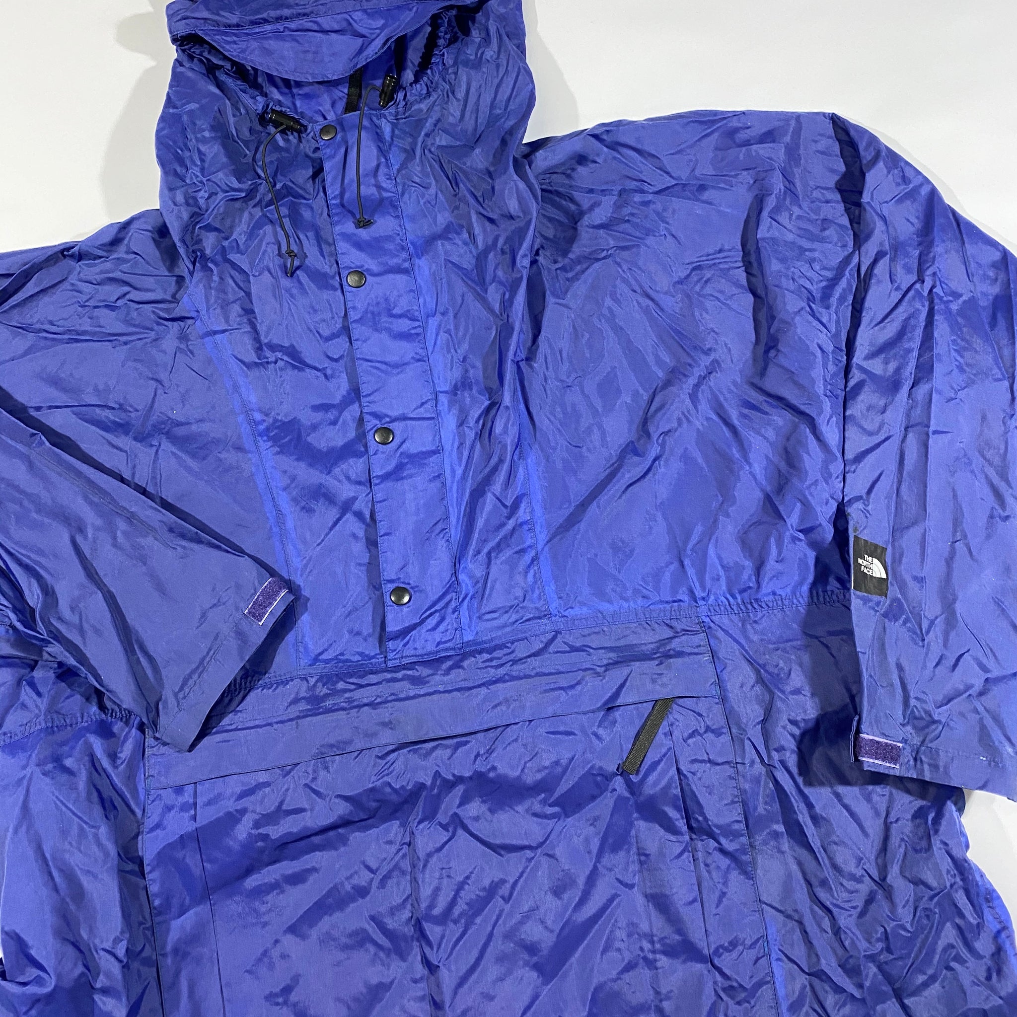 90s Northface rain jacket. folds up with snaps to become regular length large
